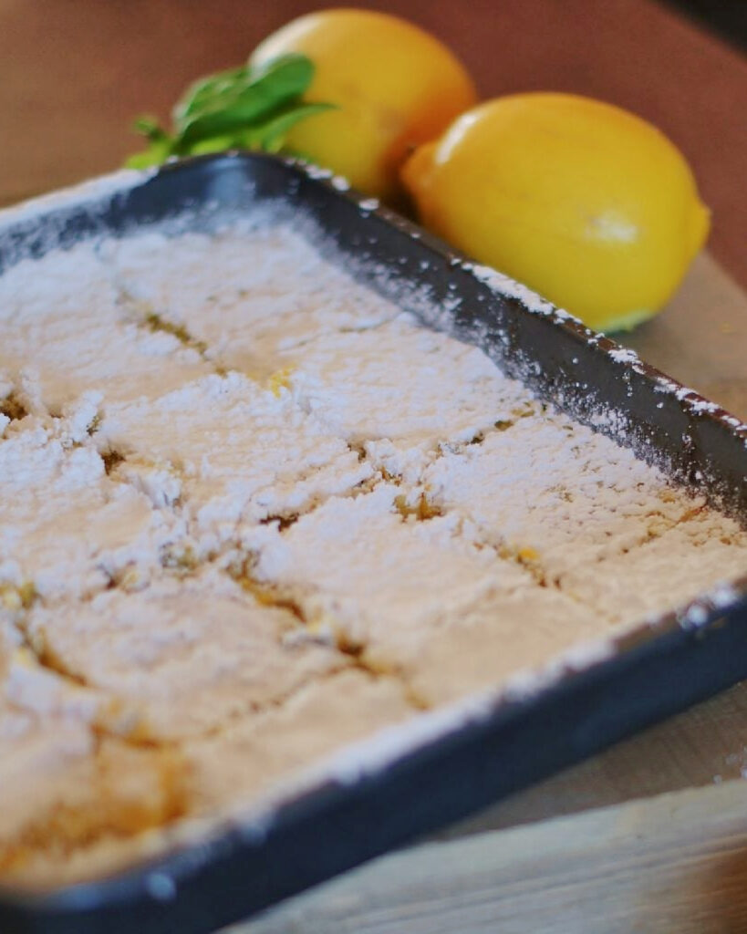 A pan of lemon squares cooked from my grandmother's recipe, dusted with powdered sugar and sliced.
