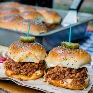 The best homemade sloppy joe slider recipe topped with pickles and a party toothpick.