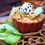 Pumpkin Butterscotch Dip being dipped with a green apple.