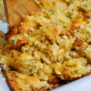 A scoop of cornbread dressing to show texture and vegetables in the finsihed casserole.
