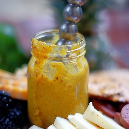 An upclose of a small jar of honey & pineapple mustard.