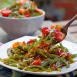 A forkful of Italian Green Bean Salad on a plate.