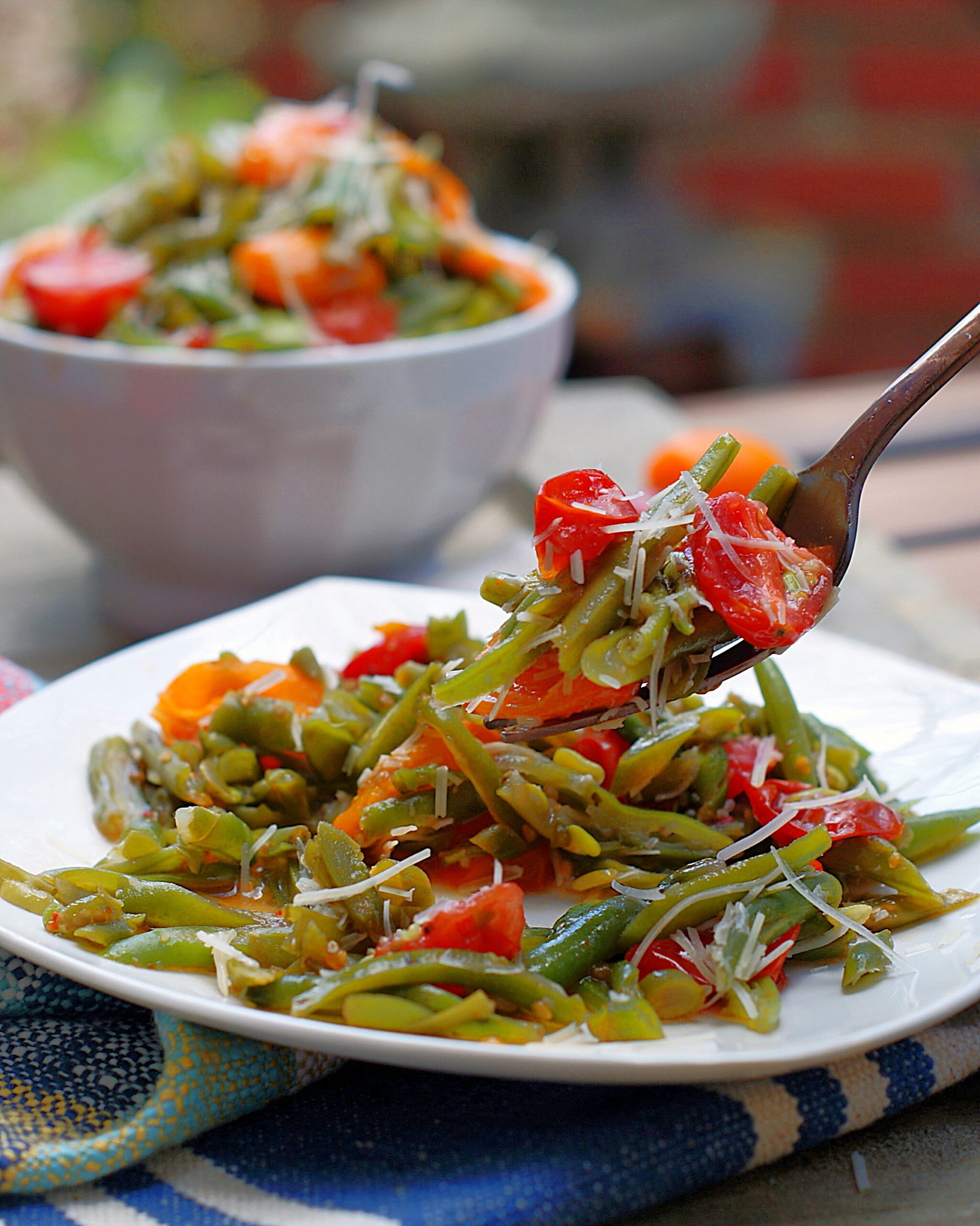 A forkful of Italian Green Bean Salad on a plate.