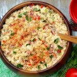 An aerial view of Southern Macaroni Salad bursting with red bell pepper, celery, red onion, sweet pickles and eggs.