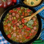 Smothered okra and tomatoes in a cast iron skillet showing how this recipe looks when it's ready on the stove top.