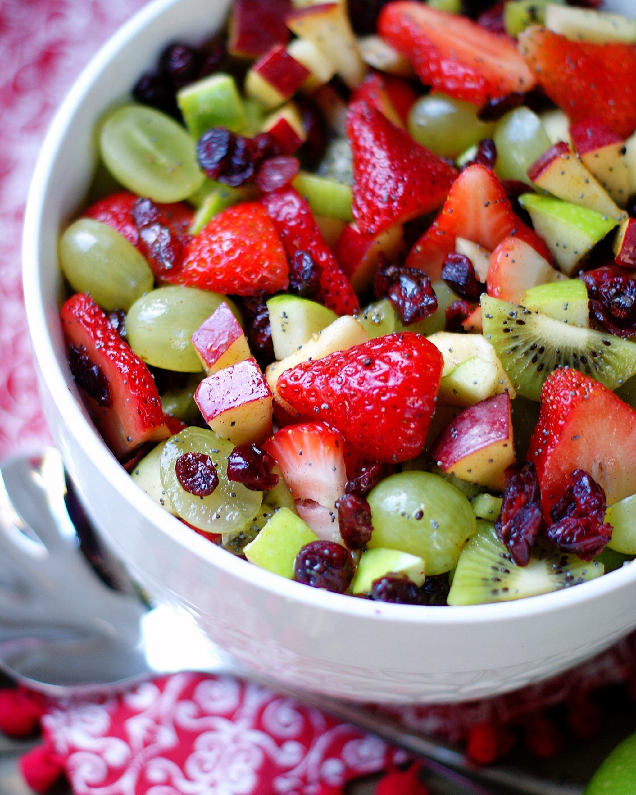 Red & green Fruit salad in a white bowl