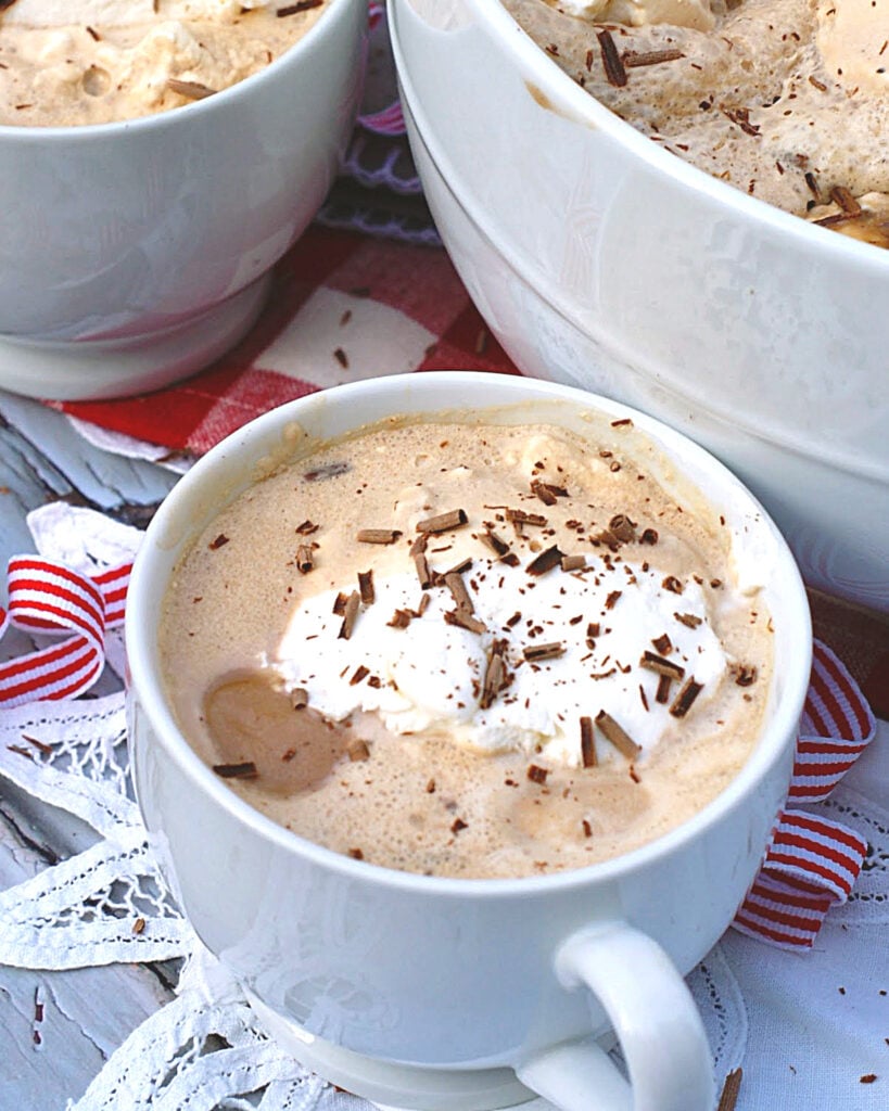 A cup of southern coffee punch topped with whipping cream and chocolate garnishes.
