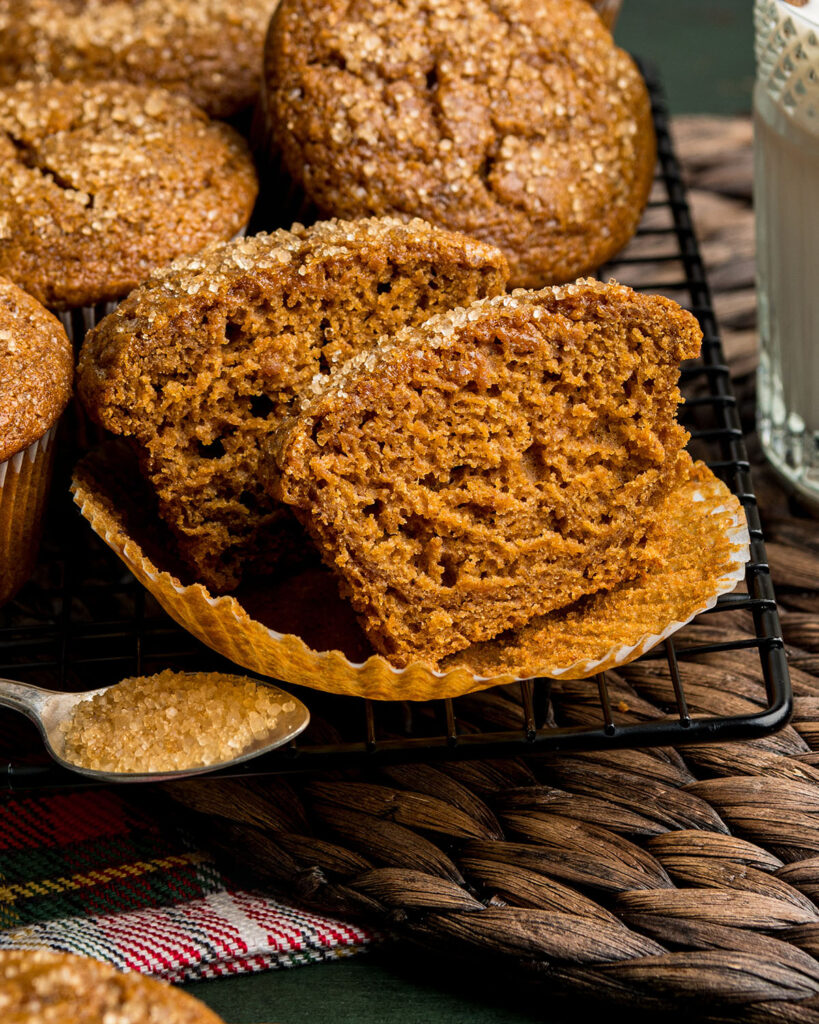 A gingerbread muffin sliced in halves to show the tender, soft texture inside the muffin.