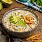 A bowl of cream cheese chicken chili with toppings to show how it can served for dinner.