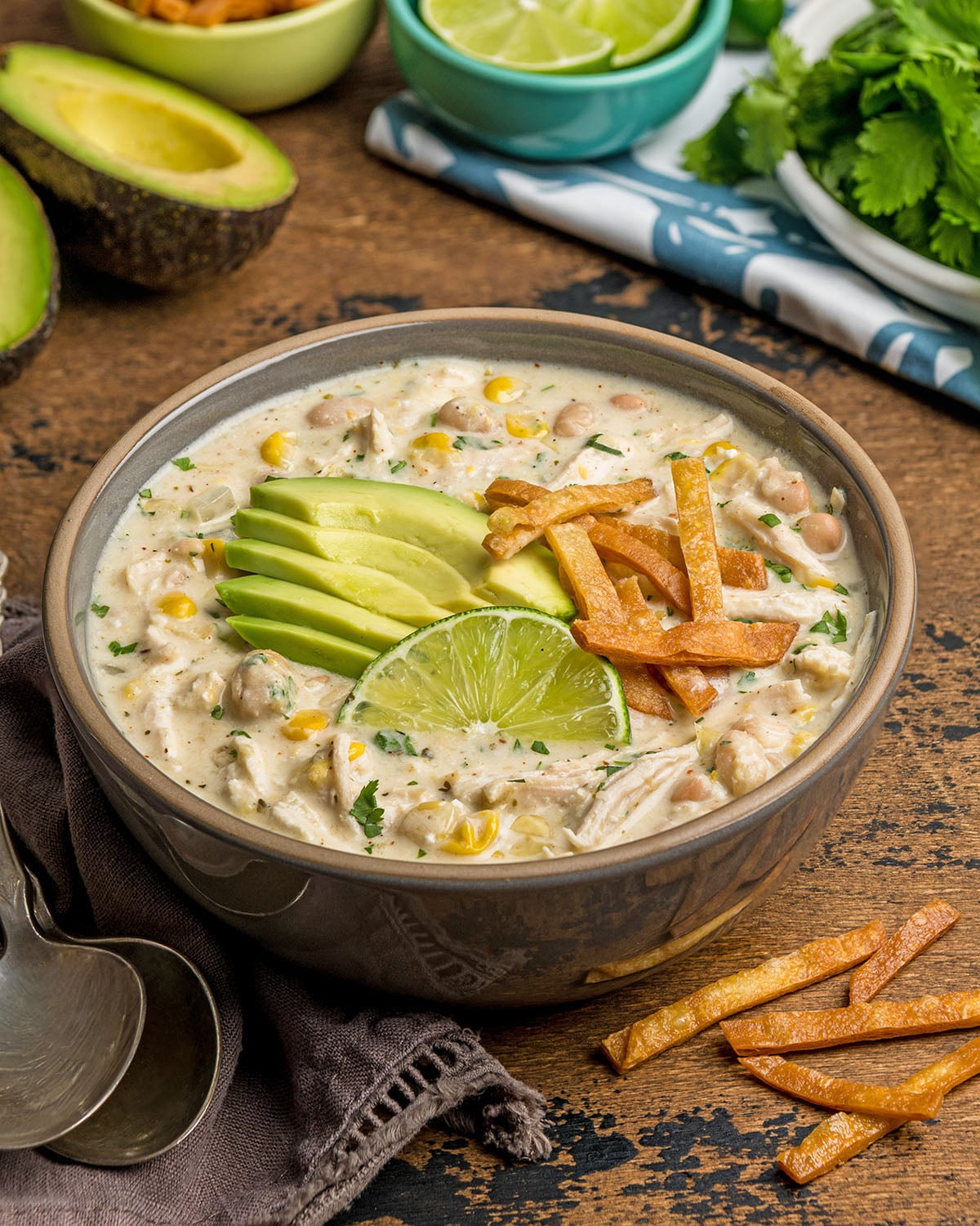 A bowl of cream cheese chicken chili with toppings to show how it can served for dinner.