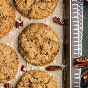 Chewy Coconut Cookie with pecans on parchment paper.
