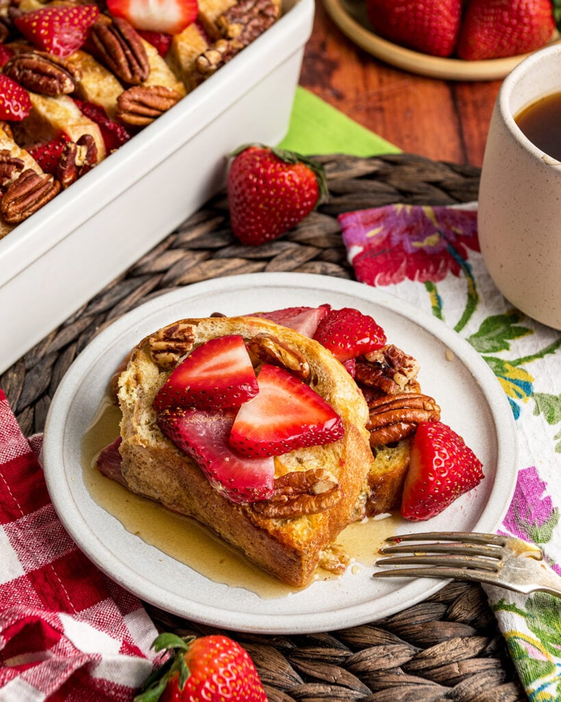 2 slices of Strawberry French Toast Casserole with warm syrup ready to be served for brunch.