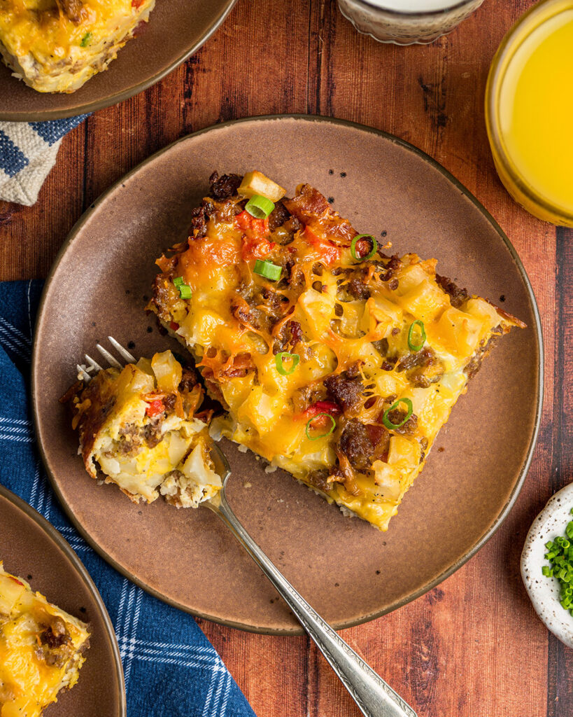 Looking down on a serving of hash brown breakfast casserole to show ingredients and texture.