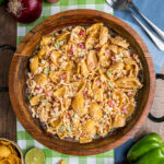 Looking down into Frito Corn Salad in a wooden bowl to show the ingredients and crunchy texture of the salad.