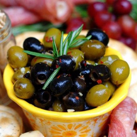 Easy Italian Marinated Olives in yellow bowl