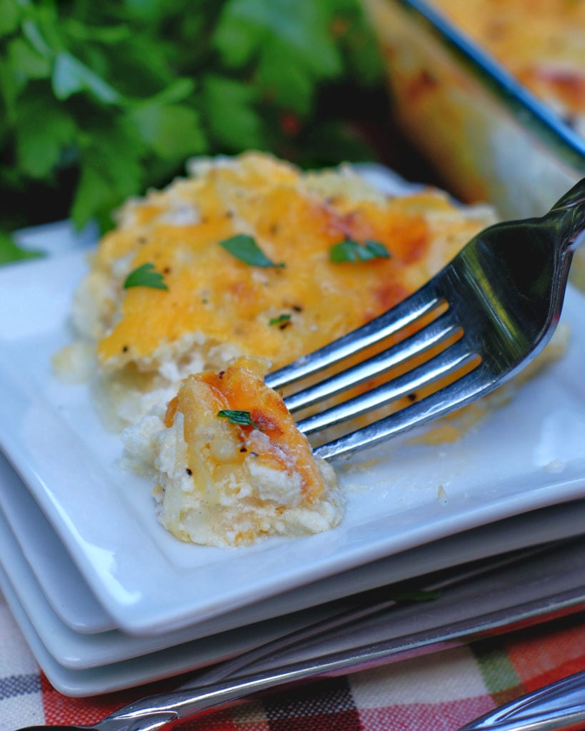 Cheesy Hashbrown Casserole on a plate with a fork