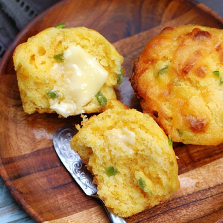 Cheddar Jalapeno Cornbread Muffins with butter on them