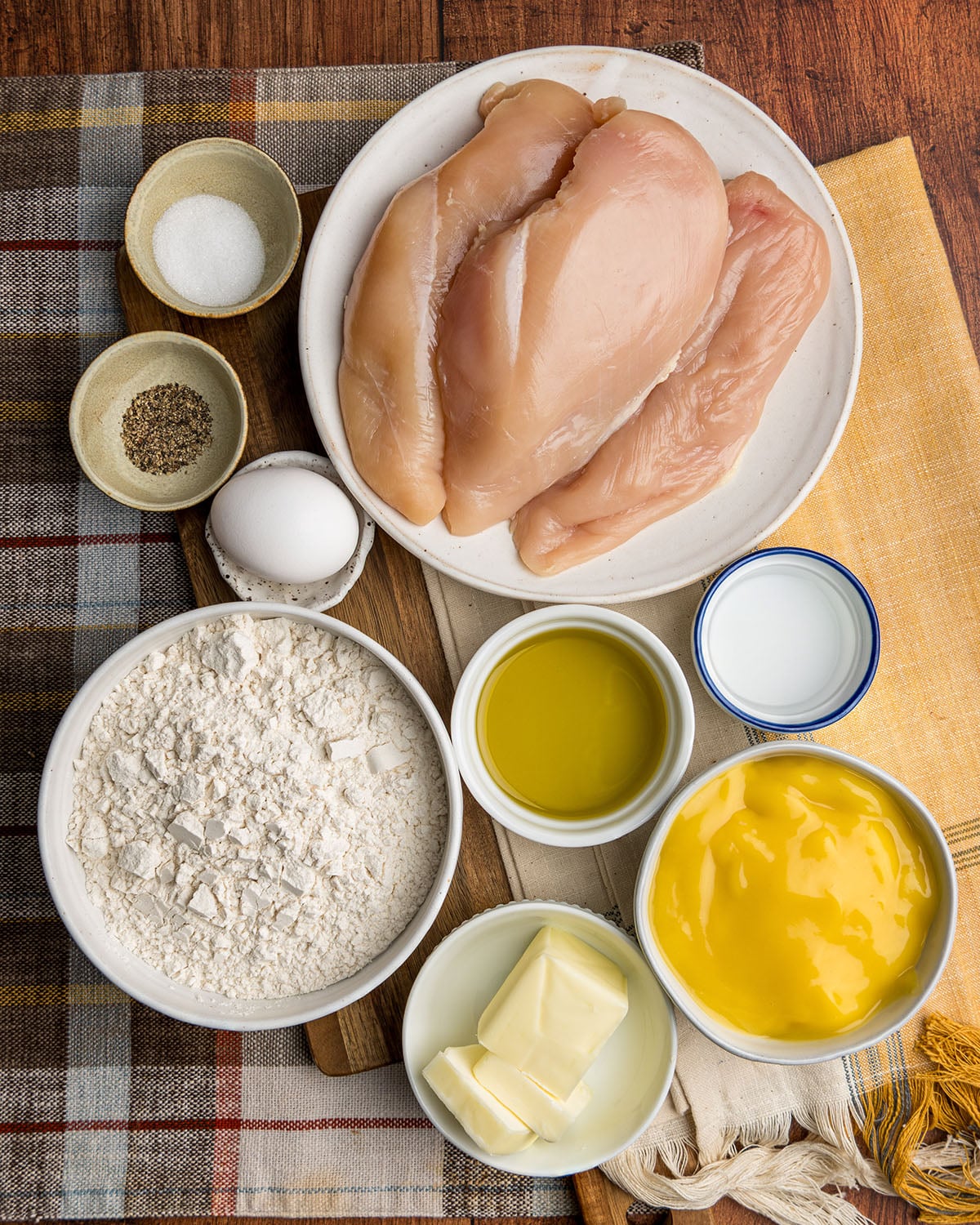 The ingredients needed to make chicken and dumplings, including cream of chicken soup, flour, butter, salt and pepper.