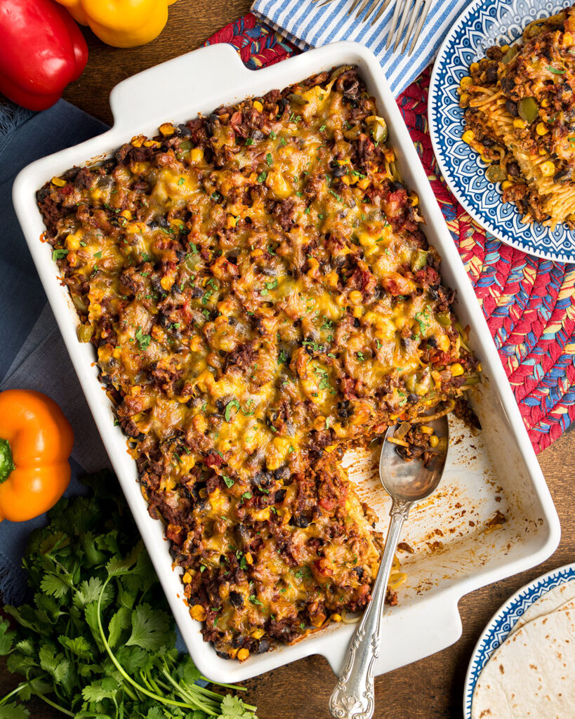 A 9X13 casserole pan of Million Dollar Mexican Spaghetti to show how the recipe can feed a big family or be served at a potluck.