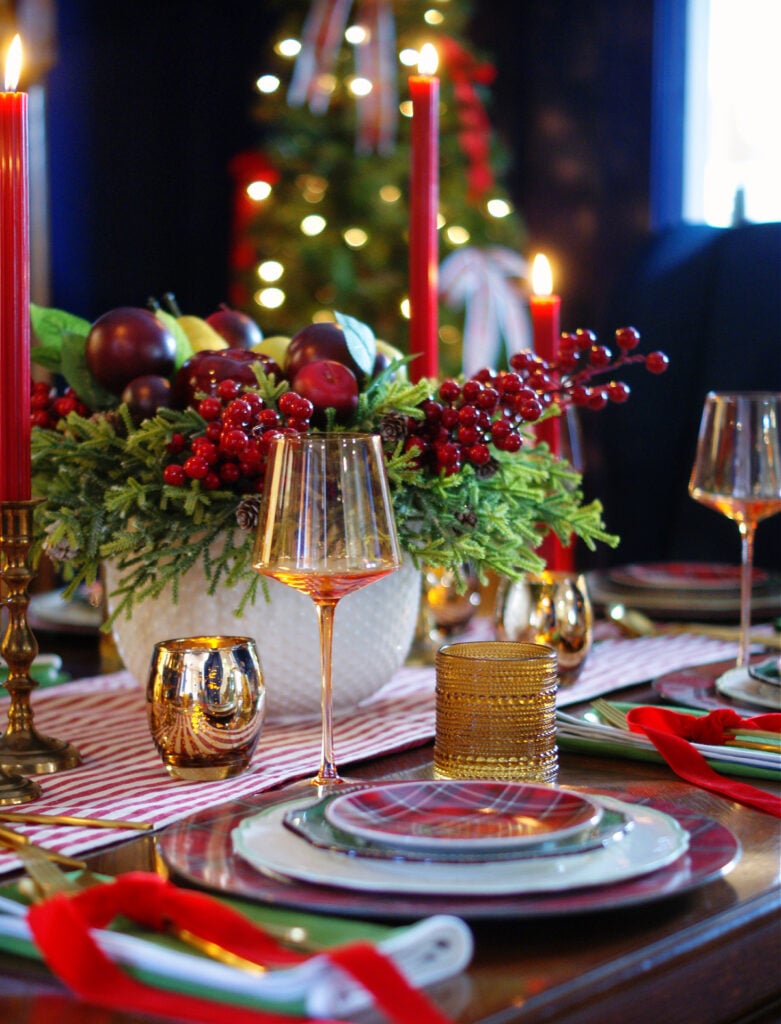 Tartan plaid Christmas plates and amber stemware with an amber beaded water glass create a glowing Christmas table.