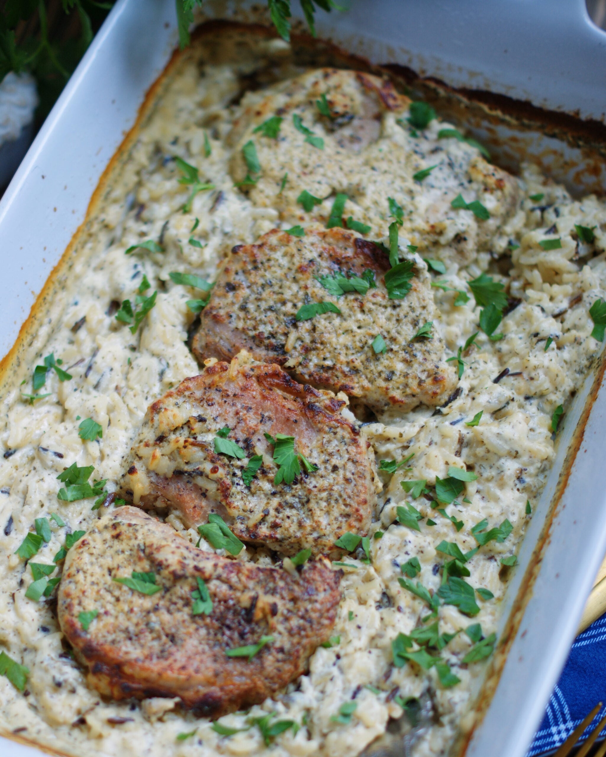 4 boneless pork chops cooked in cream of chicken soup, chicken broth and wild rice to make an all-in-one casserole dinner.
