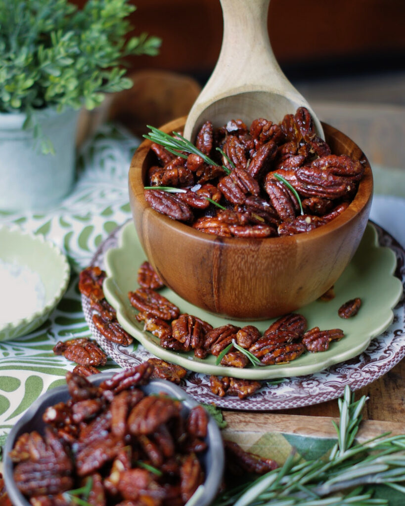 Toasted Rosemary Pecans in a wooden bowl with a wooden scoop for a casual serving idea.