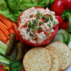 Smoked Tuna Dip served with pickles and crackers and topped with capers.