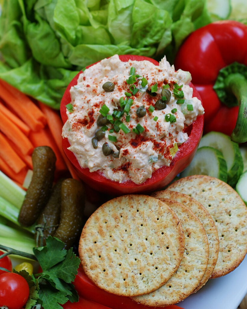 Smoked Tuna Dip served with pickles and crackers and topped with capers.