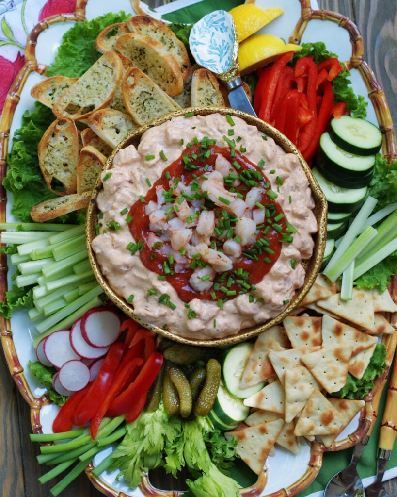 A vegetable platter with the addition of crisp pita chips and toasted crostini is a great way to serve cream cheese shrimp dip.