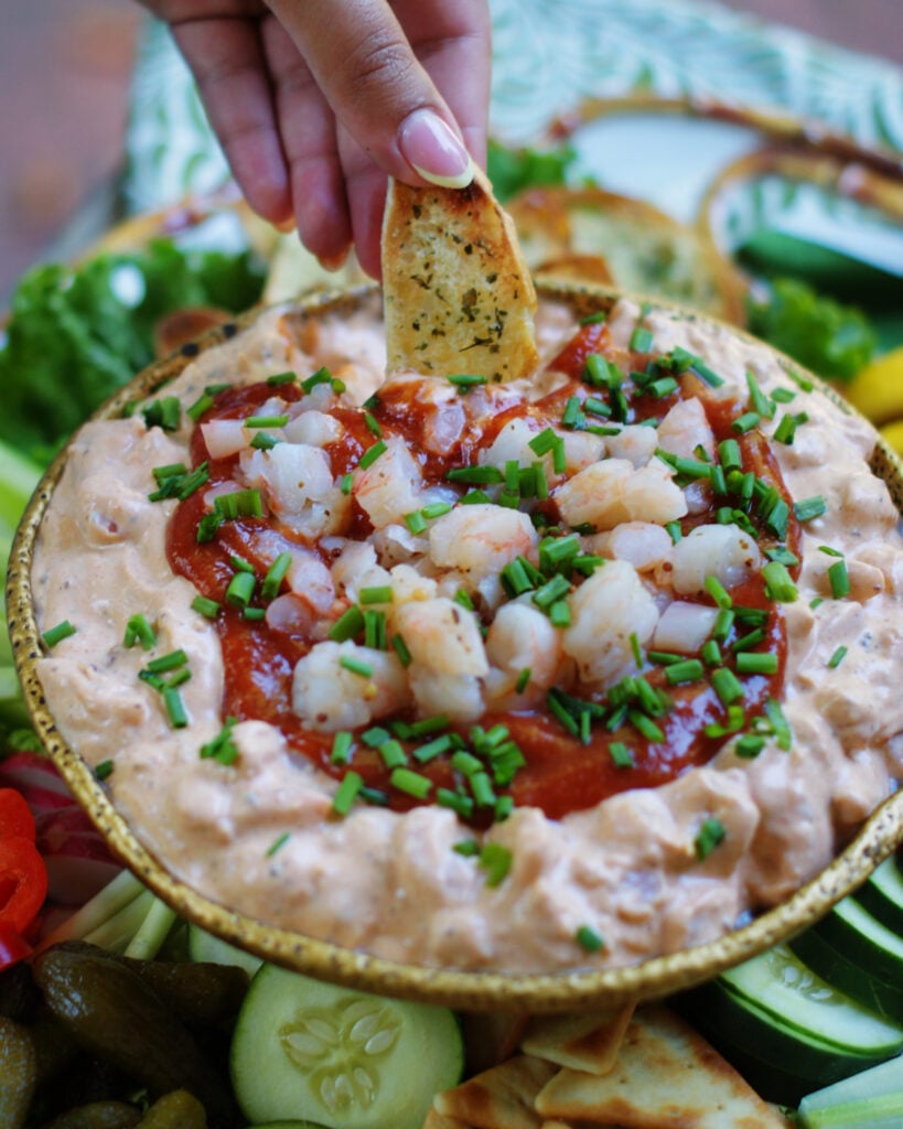 Retro cream cheese and shrimp dip is like a creamy shrimp cocktail being dipped with a crostini.