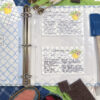 3 ring recipe binder with the divider tab and recipe card protective sleeves with recipe cards in it to show how the binder would be used in the kitchen.